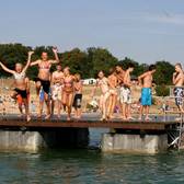 Kinder und Jugendliche haben Spaß auf der Holzinsel im Strandbad Langener Waldsee